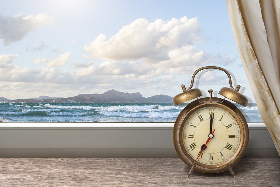 Clock on Windowsill In Front of Ocean View