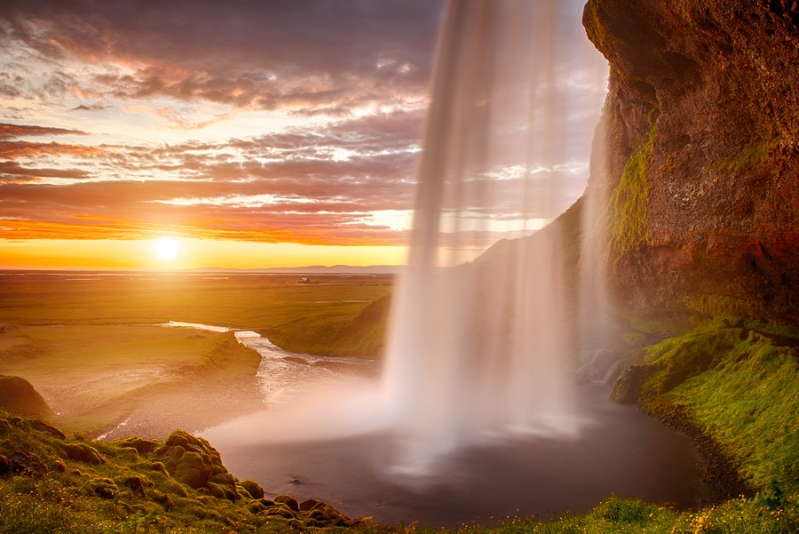 Large Waterfall With River Flowing Away Towards Sunset