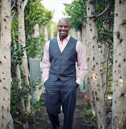 Richard Shola With Hands In Pockets Walking On A Path Through Trees