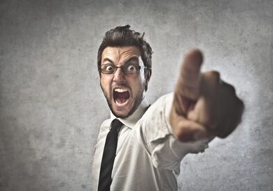 Businessman Yelling and Pointing - Workplace bullying