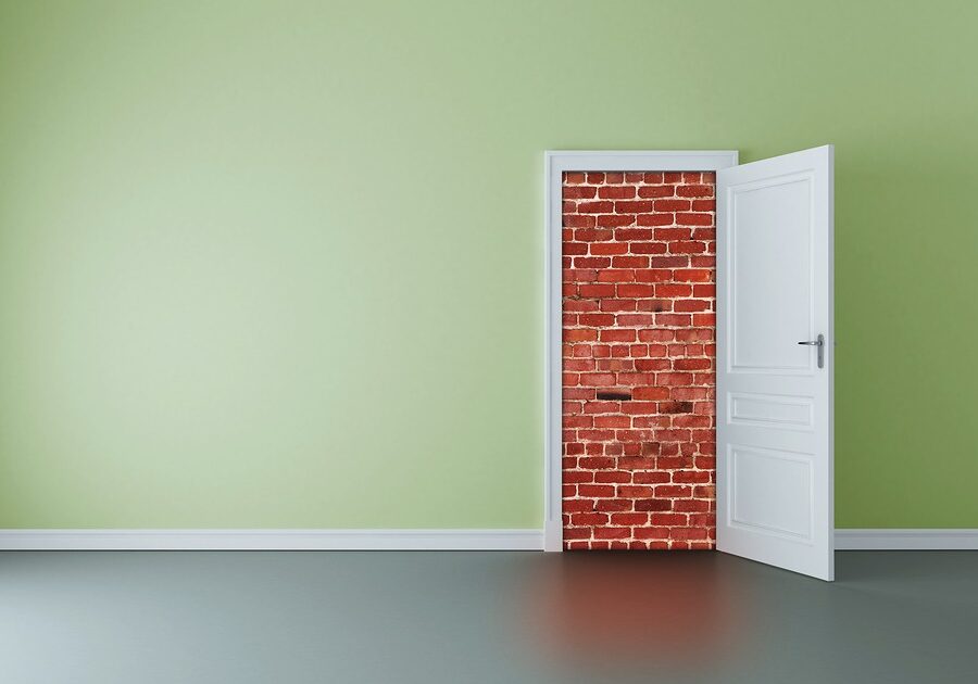 Door Open To Show a Brick Wall