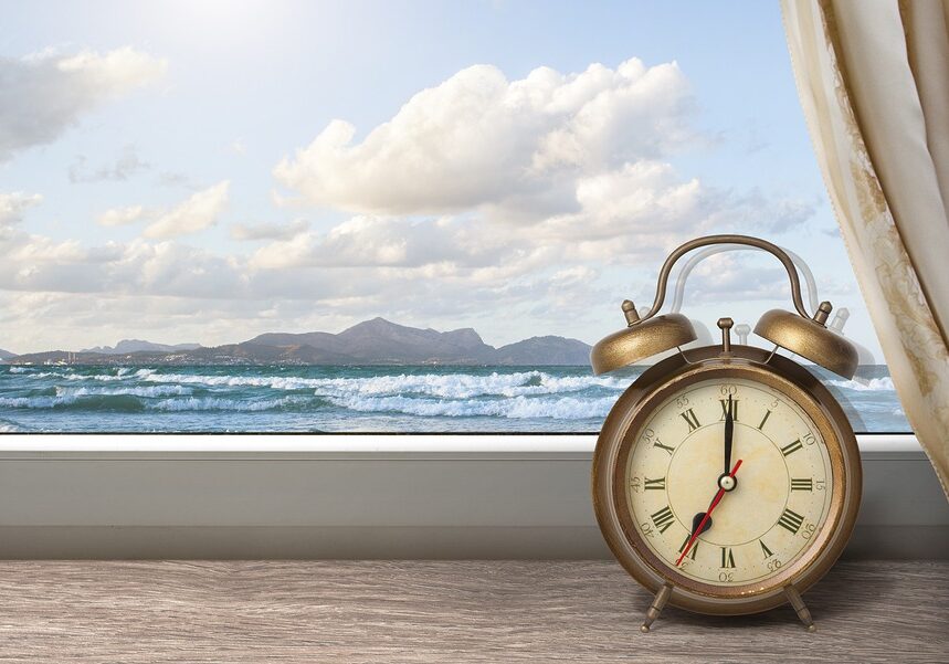 Clock on Windowsill In Front of Ocean View